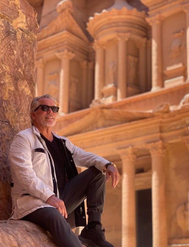 An elderly man inside some ruins