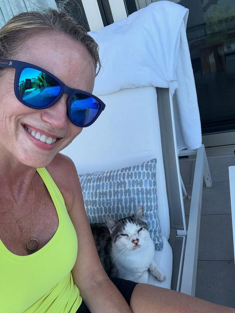 Amy Robach on vacation, poolside in Turks and Caicos with a cat