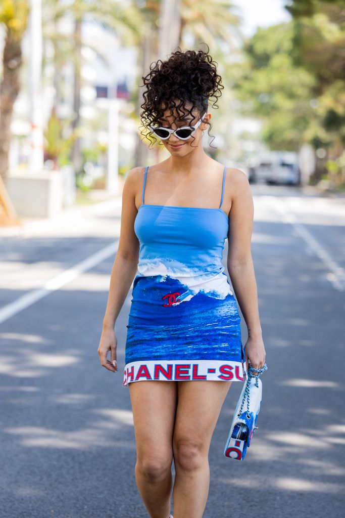 Lena Mahfouf stunned in a summer-approved blue Chanel mini dress and white sunglasses