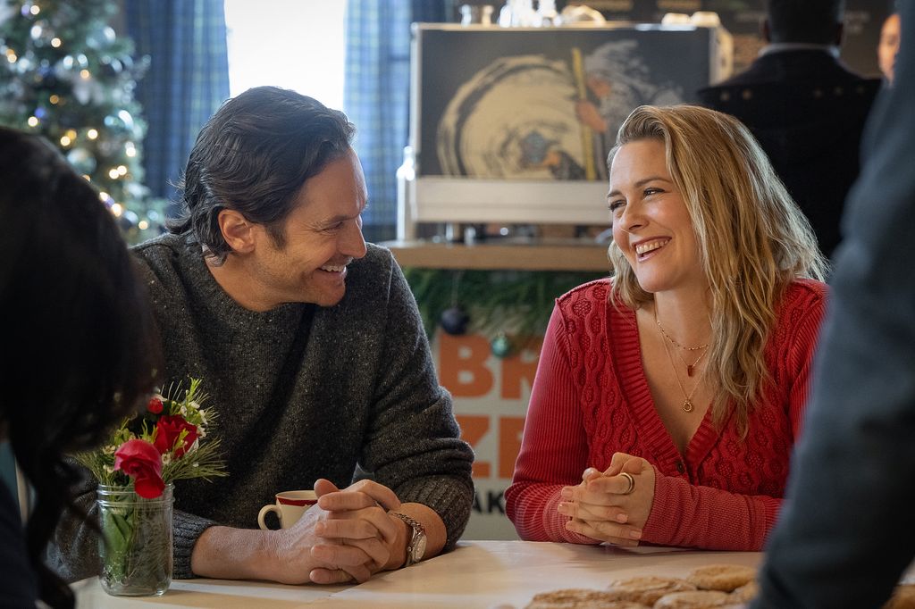 Oliver Hudson and Alicia Silverstone laughing together in A Merry Little Ex-Mas