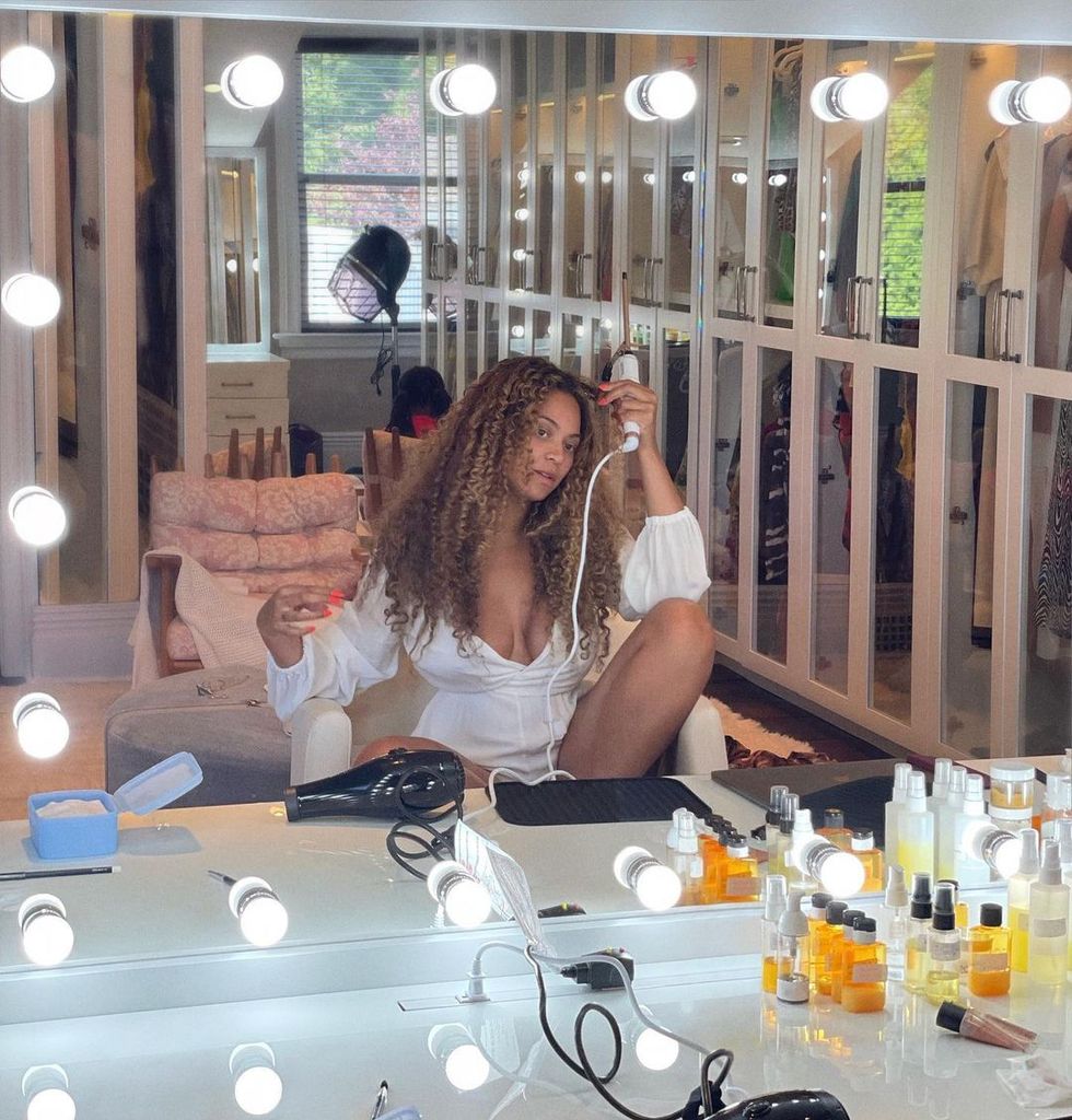 Beyoncé shares a photograph of herself caring for her hair