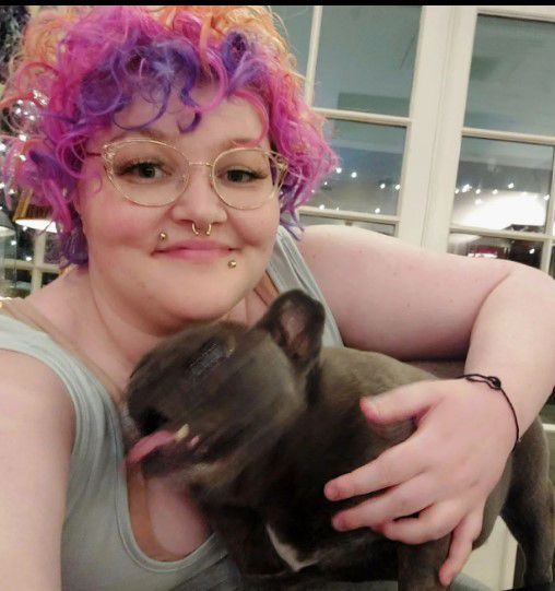 jonathan ross daughter betty ross with purple and pink hair holding pet dog