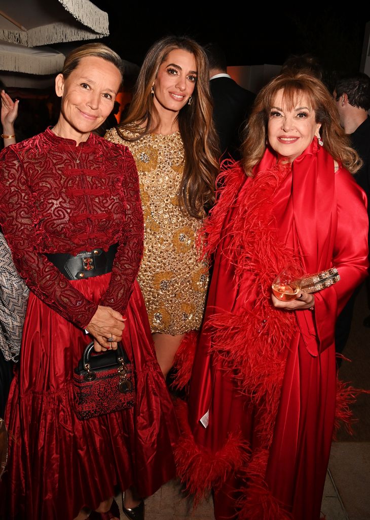 Alexandra Capton-Bikialo, Amal Clooney and Baria Alamuddin celebrate Apple Original Films' "Bono: Stories of Surrender" Cannes Film Festival World Premiere at Le Panorama Rooftop on May 16, 2025 in Cannes, France. "Bono: Stories of Surrender" premieres globally on Apple TV+ on Friday, May 30, 2025. (Photo by Dave Benett/Getty Images for Apple)