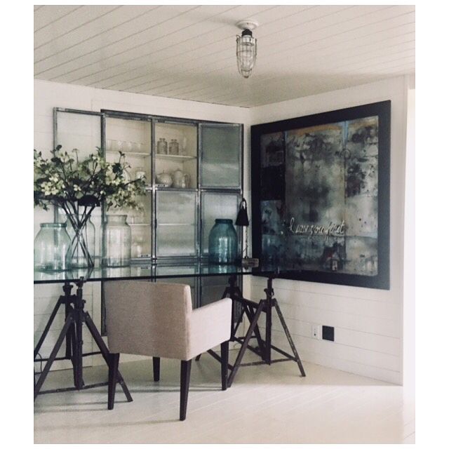 glass table and covered chair with wall art