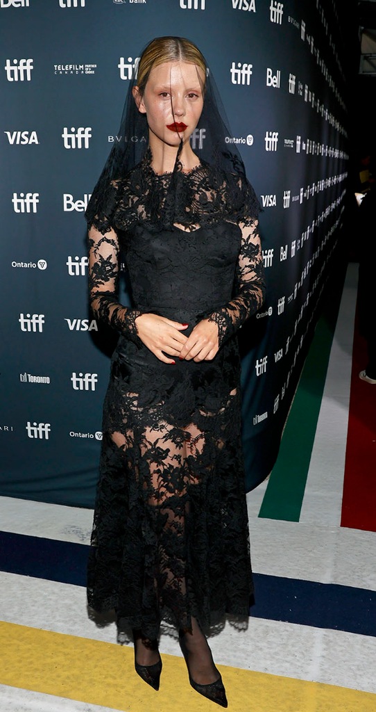 Mia Goth at the 2022 Toronto Film Festival wearing a black lace dress and matching black mesh veil