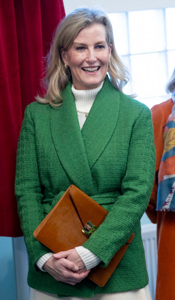Duchess of Edinbugh wearing green coat and tan bag at Katherine Low Settlement