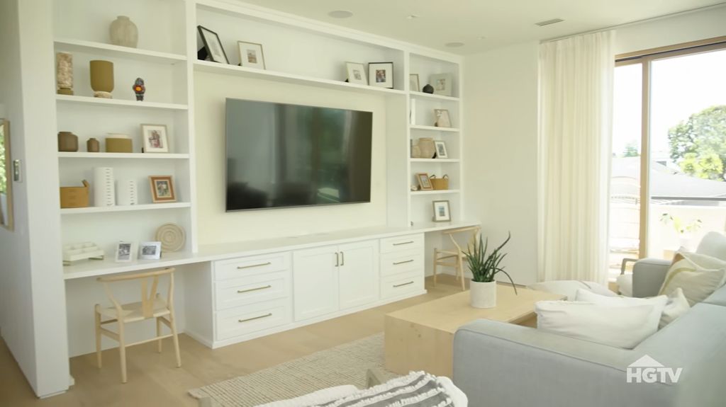 Work space in Christina Hall's home with built-in shelves surrounded by a TV