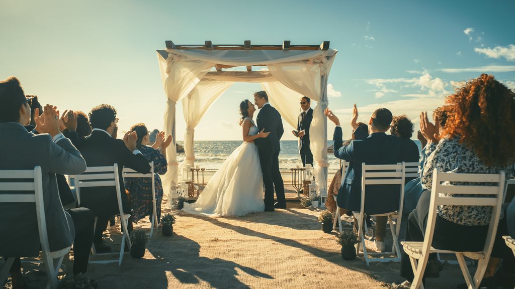 A bride and groom at a beachfront destination wedding ceremony
