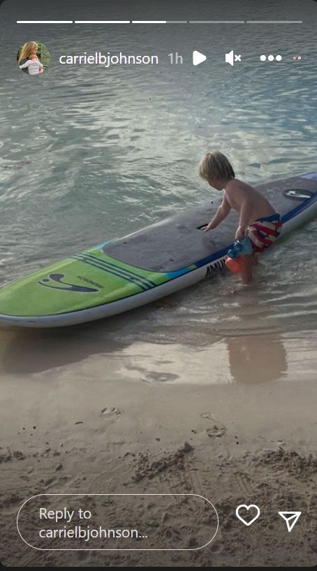 boy in the sea with surfboard 