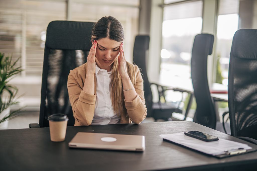 woman with headache at the office