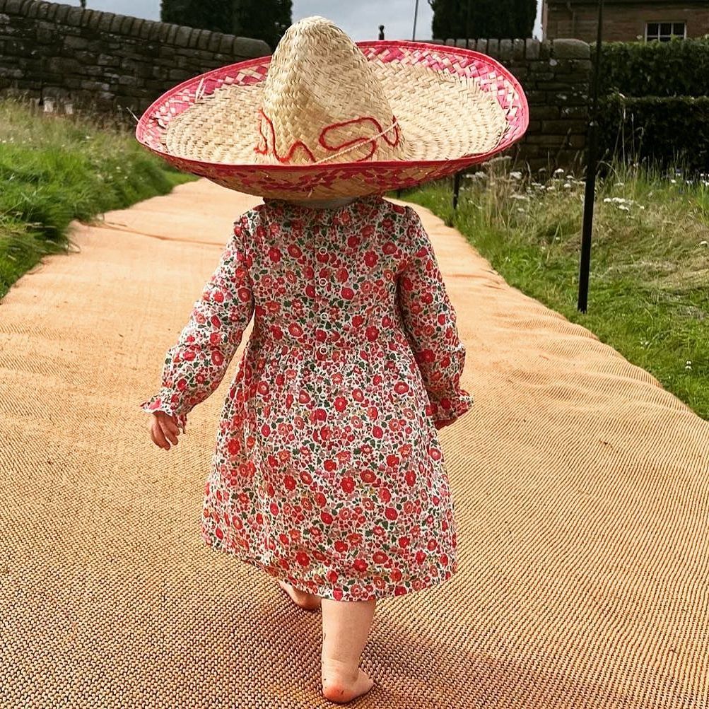 Sienna Mapelli Mozzi wearing floral dress and straw hat on her birthday