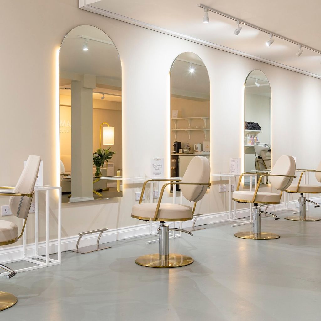 The GLAMHAIR Studio with gold chairs and big mirrors