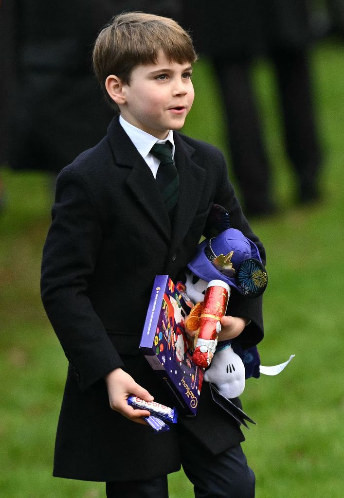 Prince Louis carries gifts from well-wishers