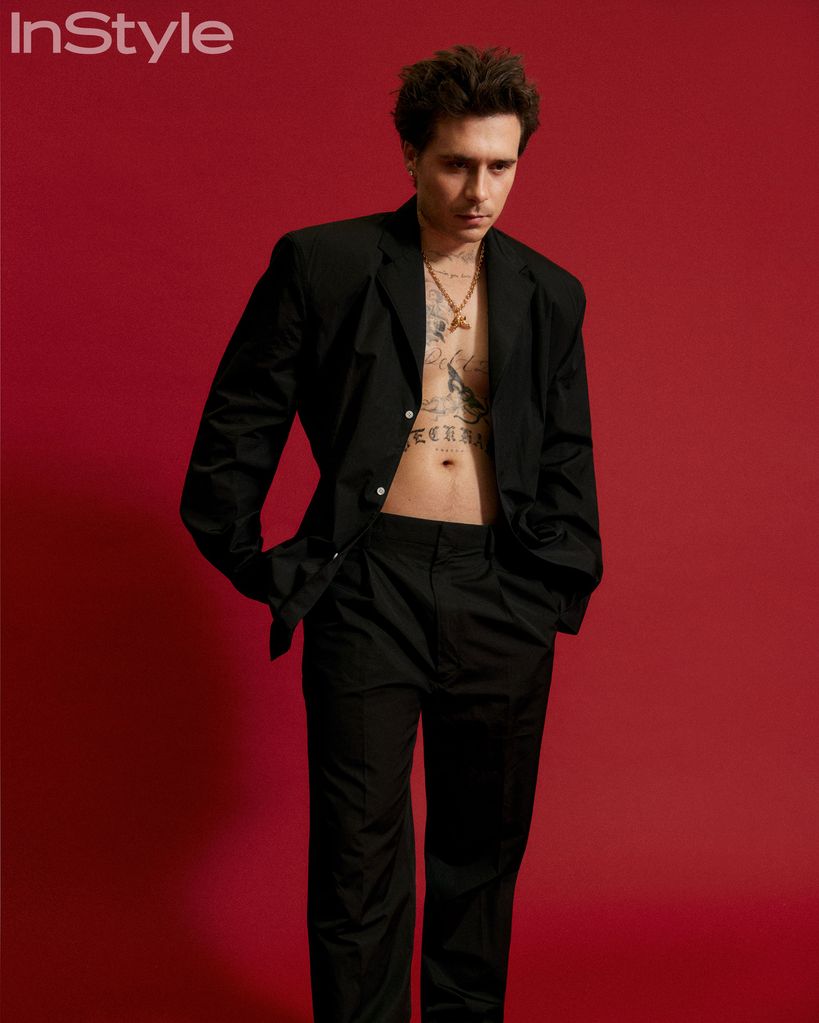 brooklyn beckham posing in black suit 