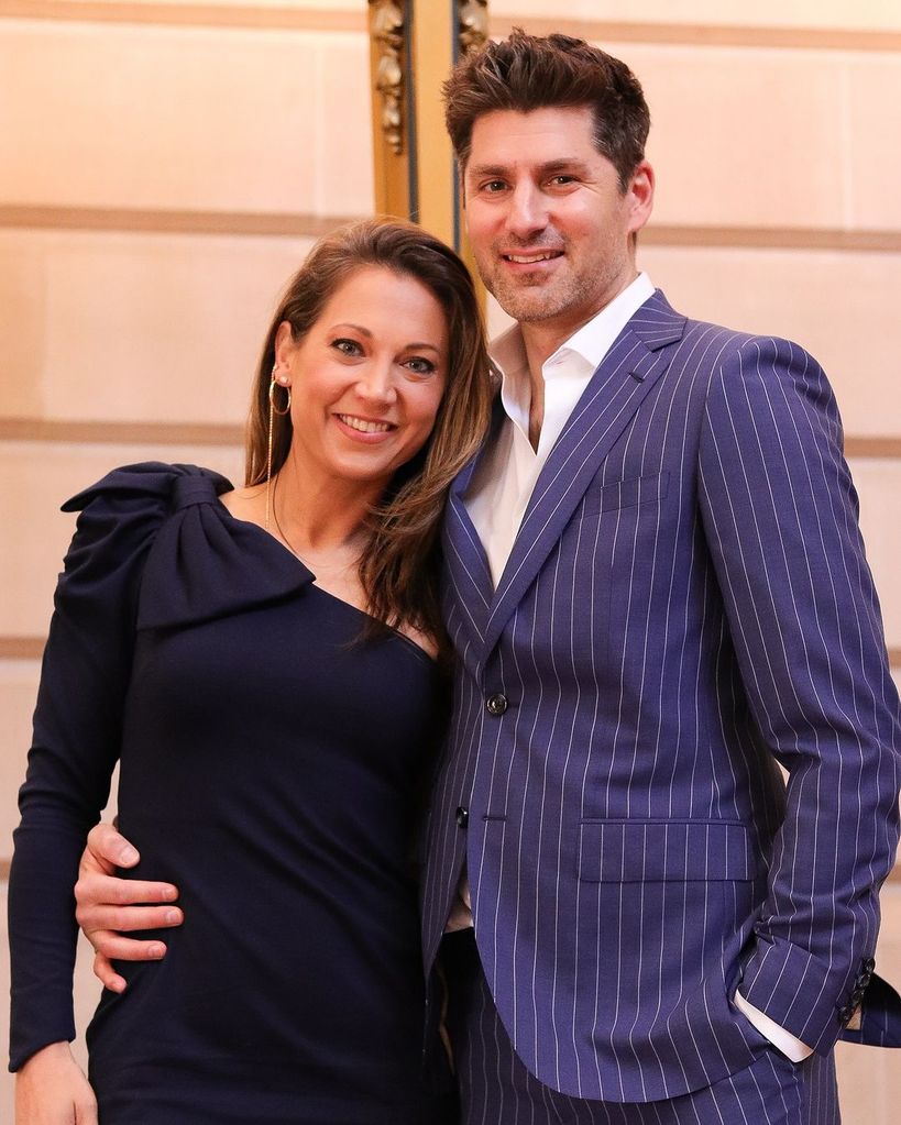 Ginger Zee in a blue one shouldered dress with her husband Ben Aaron
