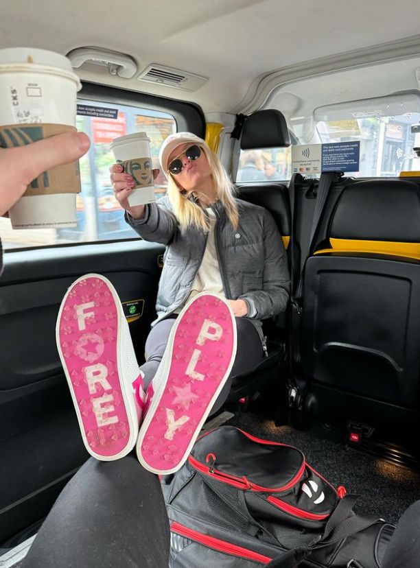 Nadiya Bychkova in a taxi with a takeaway coffee cup