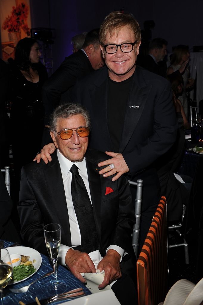 Elton John with his hands on Tony Bennett's shoulders