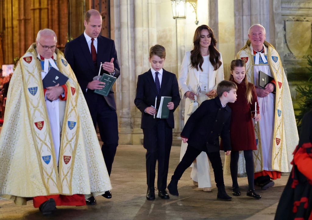 Prince Louis blowing out Princess Charlotte's candle
