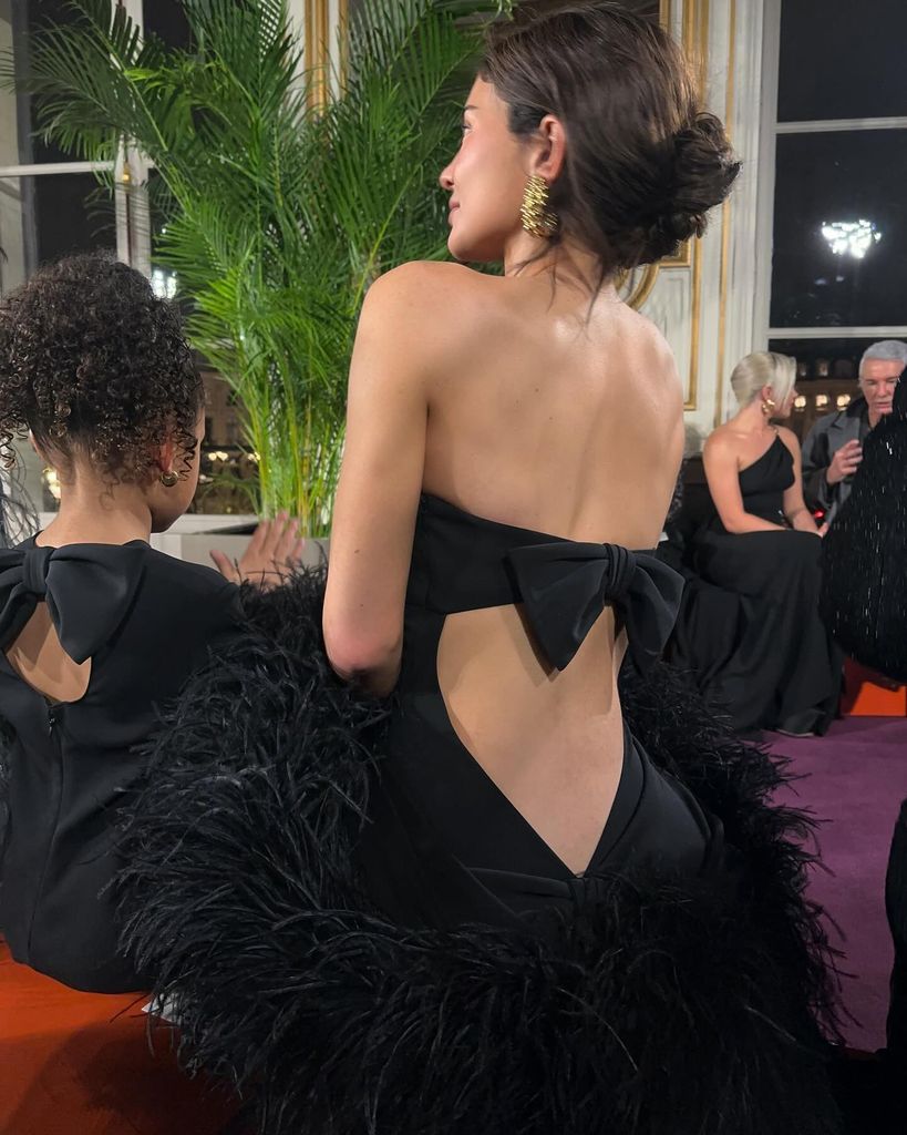 Kylie Jenner and Stormi wearing matching black backless dresses