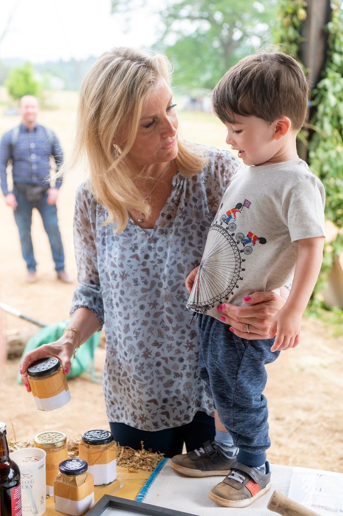 Sophie Wessex with a young boy on a farm