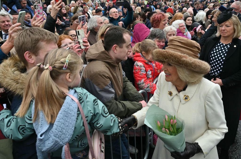 Queen Camilla greets the crowd outside Worcester Cathedral