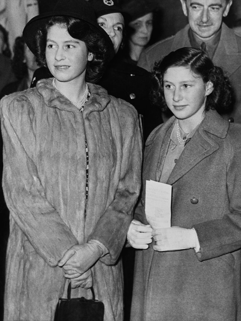 Elizabeth in 1943 beside princess margaret in coats
