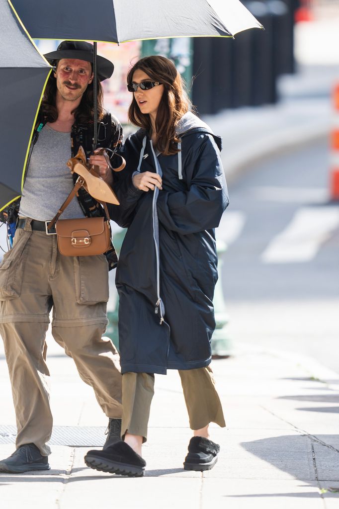 daisy edgar jones in a navy dry robe, green trousers and Gucci shades