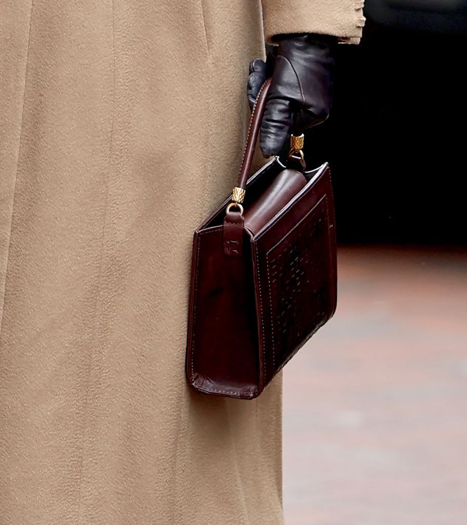 Queen Camilla carries a brown leather handbag