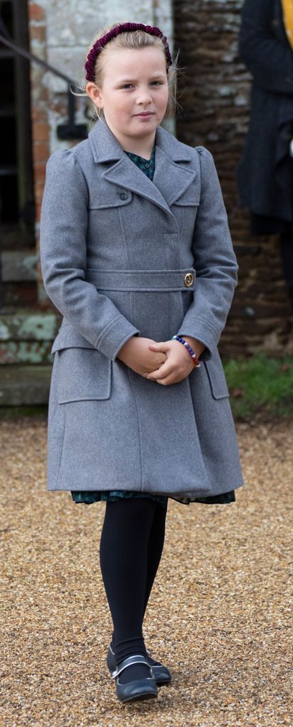 Mia Tindall in a grey jacket and red headband