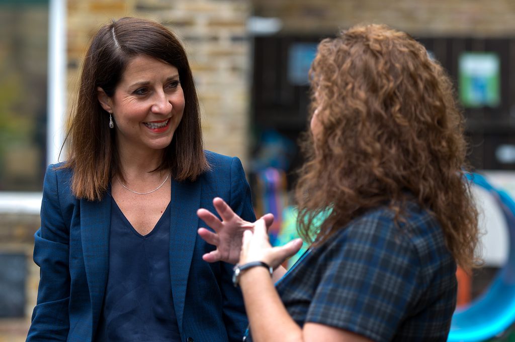 Liz Kendall speaking with a woman