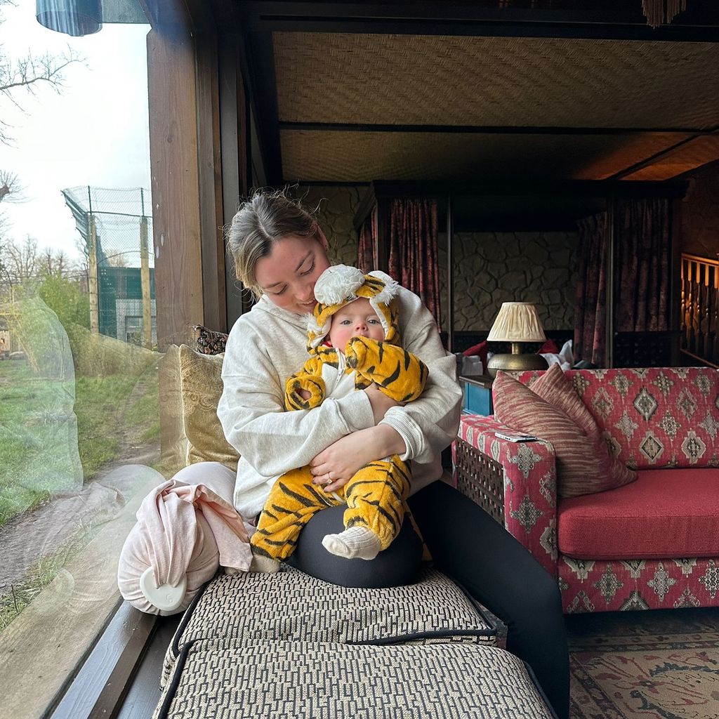 mother sitting with daughter inside safari lodge