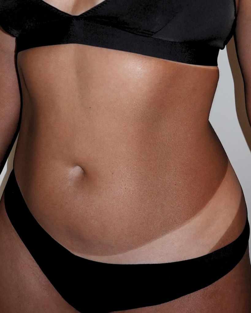 woman in black underwear with strong tan line