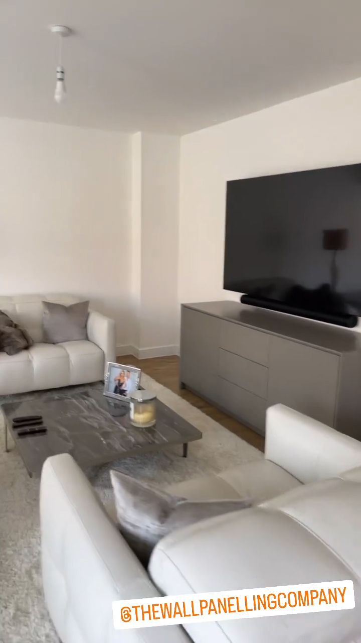 James Jordan's cream leather sofas and TV in the living room