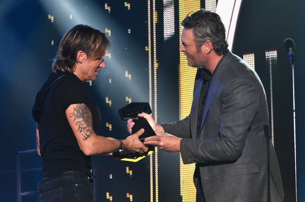  Keith Urban receives Best Male Video of the Year award from Blake Shelton onstage during the 2017 CMT Music Awards