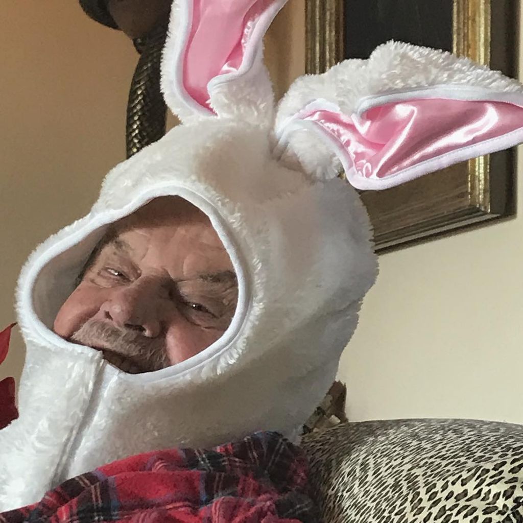 Jack Nicholson smiles for camera wearing a rabbit mask on his head