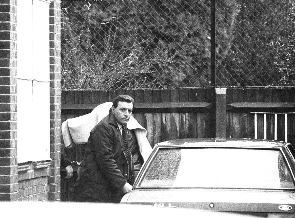 A handcuffed figure, presumed to be Brian Robinson, covered with a blanket, at Fleetham Magistrates Court