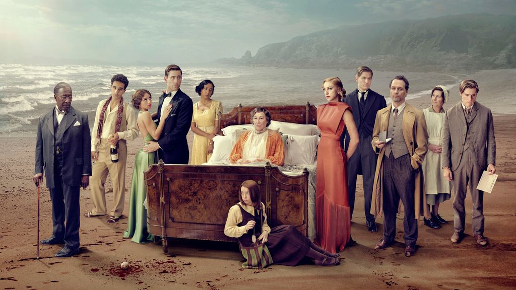 A number of people in period clothing against a beach backdrop