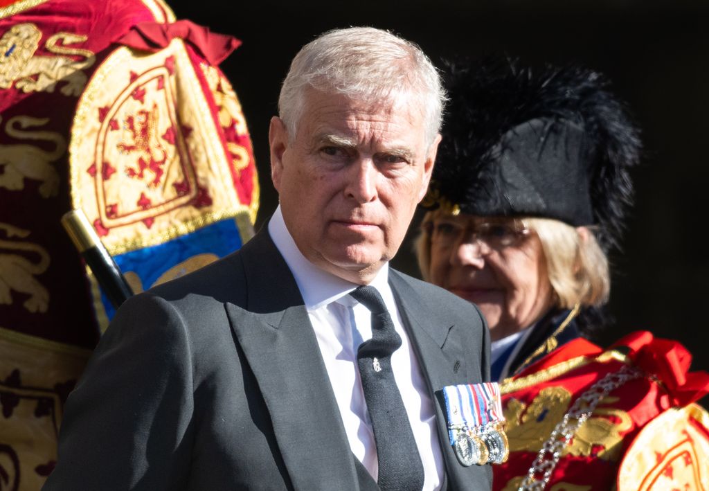 Prince Andrew wearing a charcoal suit 