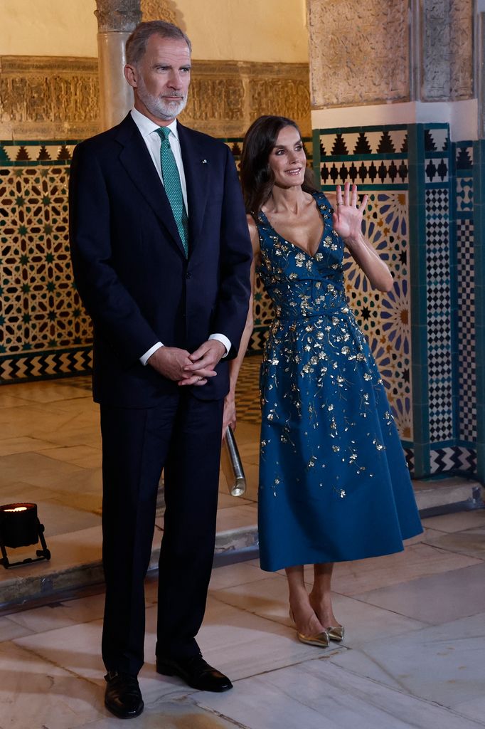 Queen Letizia of Spain waves next to his husband King Felipe VI prior to hosting a a state banquet in honour of visiting heads of state at Real Alcazar on the eve of the United Nations' IV International Conference on Financing for Development