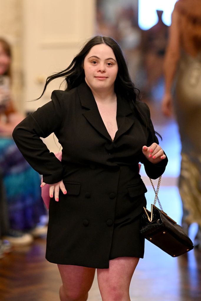 Ellie Goldstein walking a runway