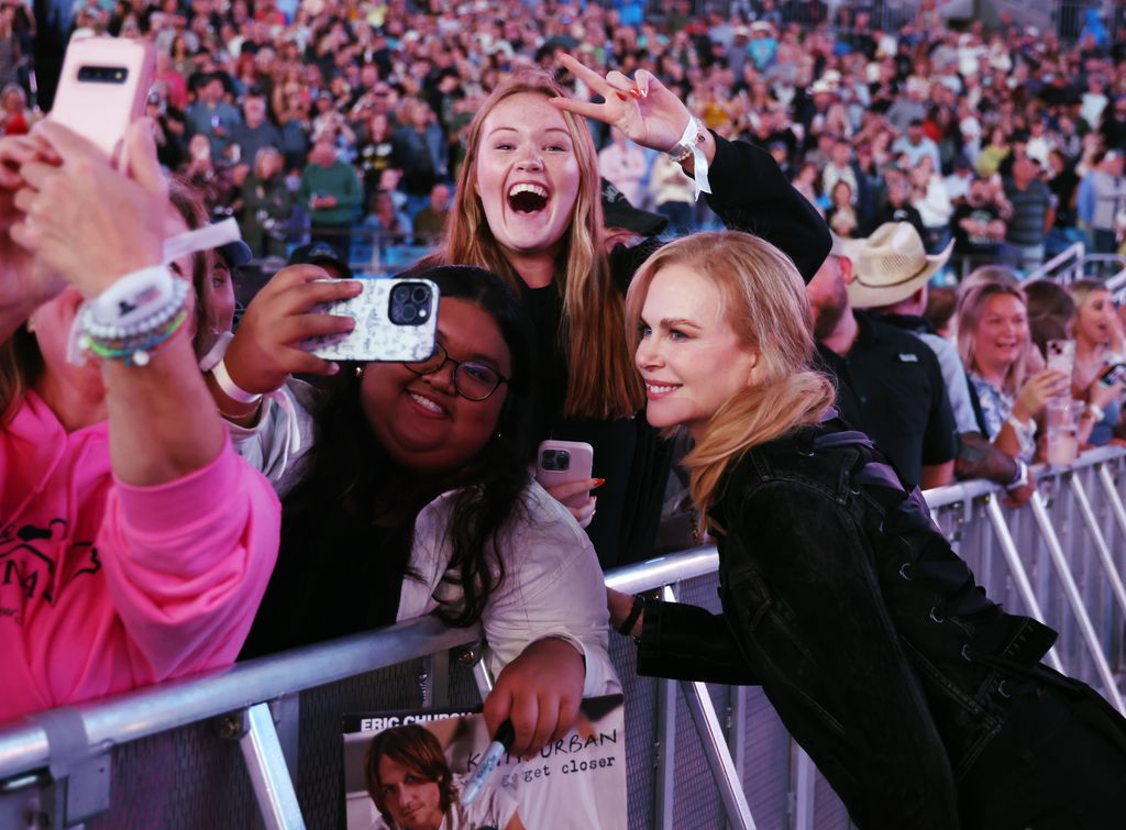 Nicole Kidman poses with fans at the “Concert For Carolina” benefit concert at Bank of America Stadium on October 26, 2024 in Charlotte, North Carolina.