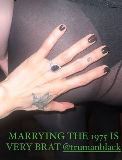 Photo of a hand with an engagement ring 