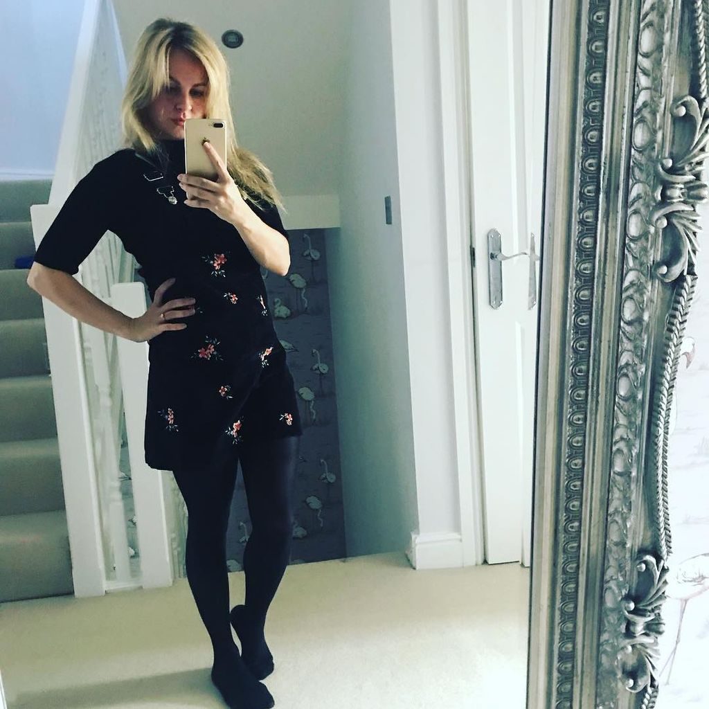 Tina O'Brien taking a mirror selfie in her hallway