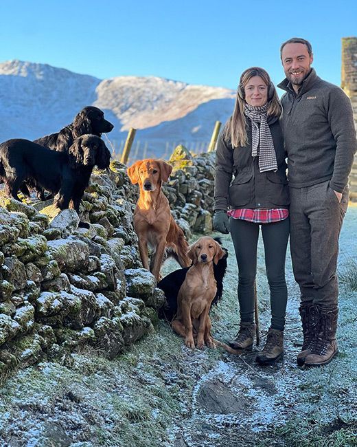 James Middleton and wifw Alizee Thevenet pose outside with their dogs