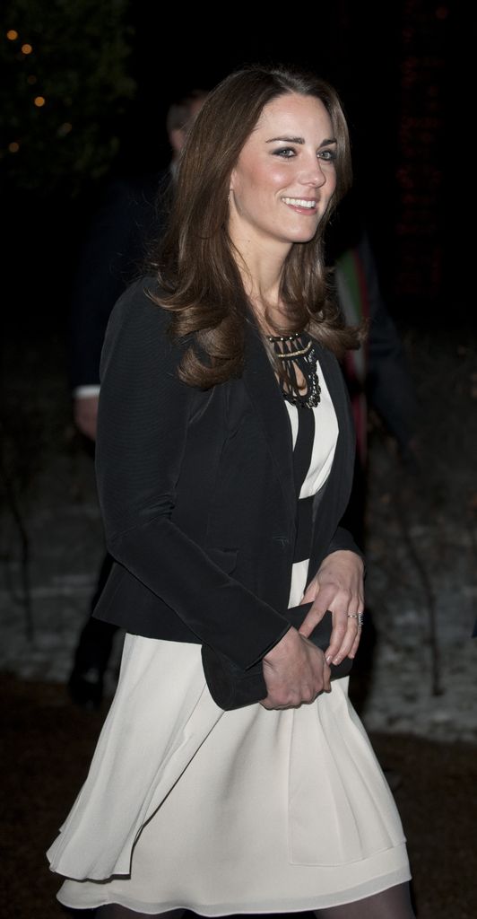 kate in white mini dress and black blazer