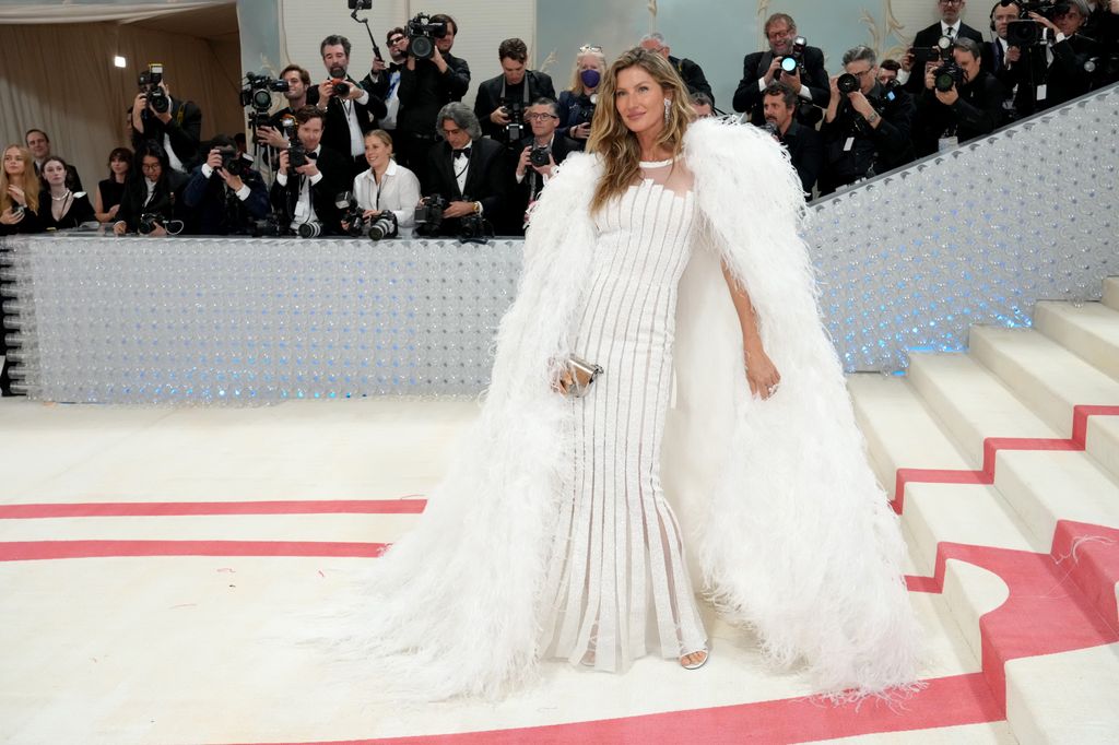 Gisele Bundchen in white dress and feathers