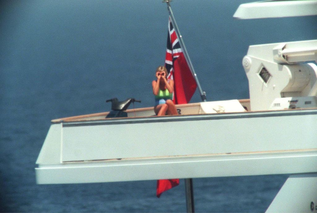 Princess Diana in a green and blue swimsuit on the deck of a yacht