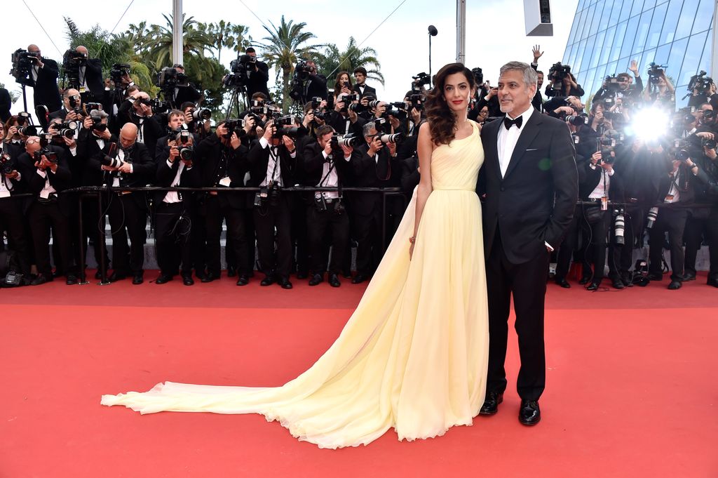 George and Amal on the red carpet with their arms around each other