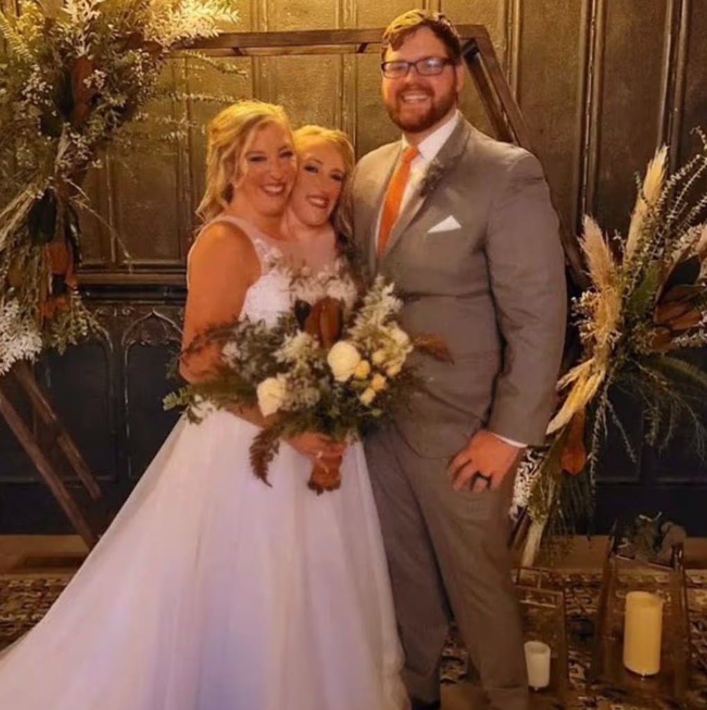  Abby and Brittany Hensel on wedding day holding flowers standing next to Josh Bowling
