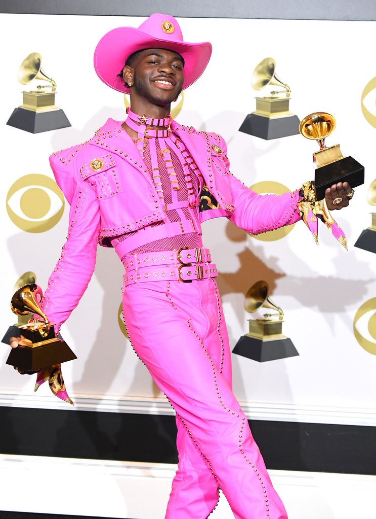  Lil Nas X poses at the 62nd Annual GRAMMY Awards in a Versace Pink suit